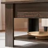 A close-up view of the corner of a dark brown wooden coffee table, showing its texture and construction. Produktbild-Vorschau