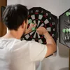 A man playing darts in a room. Náhľad obrázku produktu