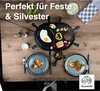 A raclette grill set up on a wooden table with food and plates. Produktbild-Vorschau
