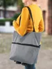 A person is walking outdoors carrying a gray shopping trolley bag. Náhľad obrázku produktu