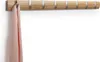 A pink scarf hanging from a wooden coat rack with silver hooks. Náhľad obrázku produktu