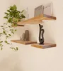 Two wooden shelves mounted on a wall, decorated with a plant, books, and sculptures. Produktbild-Vorschau