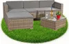 A sectional outdoor sofa set with a coffee table and ottoman on a patch of grass. Podgląd zdjęcia produktu