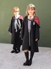 Two children dressed in Harry Potter costumes stand in front of a green wall. Produktbild-Vorschau
