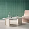A modern living room scene with a coffee table, chair, and decorative items. Produktbild-Vorschau
