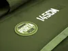 A close-up view of a green fabric product with text and a logo. Produktbild-Vorschau
