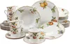 A collection of white porcelain dinnerware with fruit and leaf motifs, arranged on a white background. Produktbild-Vorschau