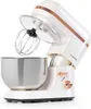 A white and rose gold stand mixer with a stainless steel bowl and whisk attachment, shown against a white background. Produktbild-Vorschau