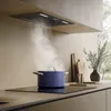 A blue pot is cooking on a black induction stovetop, with steam rising towards a built-in range hood. Anteprima dell’immagine prodotto