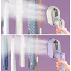 Two split images showing a handheld garment steamer being used on clothes hanging on a rack. The top image shows a white and gray steamer, and the bottom image shows a purple and pink steamer. Produktbild-Vorschau