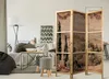 A living room scene with a sofa, coffee table, floor lamp, and a decorative screen. Náhled obrázku produktu
