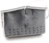 A gray electric foot warmer with a white lining. Produktbild-Vorschau