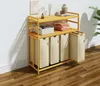 A yellow laundry sorter with beige fabric bins is shown against a white wall and wooden floor. Anteprima dell’immagine prodotto