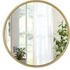 A round mirror with a golden frame is shown, reflecting a window with white curtains and a potted plant. Produktbild-Vorschau