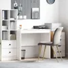 A clean, modern home office setup with a white desk, a white shelving unit, and a gray office chair. Podgląd zdjęcia produktu