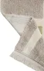 A close-up view of a folded rug, showing the texture and fringe. Voir les images du produit