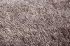 A close-up view of a shaggy rug with long fibers. Produktbild-Vorschau
