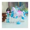A doll and a unicorn toy are displayed on a white surface with a blurred, colorful background. Anteprima dell’immagine prodotto
