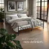 A bedroom scene with a bed, nightstand, and large windows. Náhled obrázku produktu