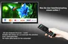 A hand holding a remote control is pointing towards a television screen displaying various channel logos and a nature scene. The scene is set against a dark, gradient background. Produktbild-Vorschau