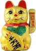 A golden Maneki Neko cat figurine with red and green accents, holding a golden ingot with Chinese characters. Produktbild-Vorschau