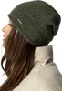 Close-up profile of a woman wearing a green beanie and a cream jacket. Produktbild-Vorschau