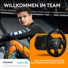 A man in racing attire is shown with a racing wheel and base, with stadium seating in the background. Produktbild-Vorschau