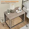 A dog crate that doubles as a side table, placed next to a bed in a bedroom setting. Produktbild-Vorschau