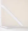 Close up of a cream-colored mattress protector corner with an elastic strap. Náhled obrázku produktu