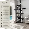 A cat tree is shown in a living room setting with a window and sofa in the background. Text overlays describe the features of the cat tree. Náhled obrázku produktu