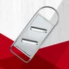 A stainless steel vegetable slicer is shown against a background of white wood grain and red geometric shapes. Produktbild-Vorschau