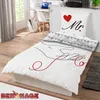 A bedroom scene with a bed made with Mr. & Mrs. themed bedding. Produktbild-Vorschau