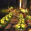 A garden path illuminated by solar flower lights at night. Náhled obrázku produktu