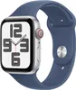 A silver Apple Watch with a blue sport band is shown against a white background. Náhled obrázku produktu