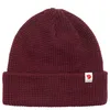 A maroon knitted hat with a small white logo patch on the front. Náhled obrázku produktu