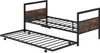 A metal bed frame with a pull-out trundle bed, both featuring wooden headboards. Produktbild-Vorschau