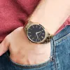 A person wearing a watch and jeans. Anteprima dell’immagine prodotto
