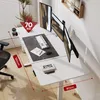 A modern home office setup with a white standing desk, multiple monitors, and a chair. Podgląd zdjęcia produktu