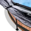A close-up view of the edge of a wooden pool with a clear cover over it, showing the texture of the wood and the transparent material of the cover. Náhled obrázku produktu
