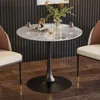 A round marble-top table with two chairs in a dining or kitchen setting. Produktbild-Vorschau
