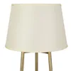 A close-up view of the top part of a floor lamp with a cream-colored lampshade and gold-colored legs. Podgląd zdjęcia produktu