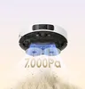 A robot vacuum cleaner is shown from underneath, actively cleaning a floor and lifting dirt. Produktbild-Vorschau