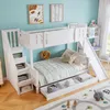 A children's bunk bed with a slide and storage drawers, set up in a bedroom with decorative pictures on the wall. Náhled obrázku produktu