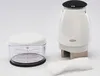 A white manual food chopper and a measuring cup are displayed on a white background. Produktbild-Vorschau