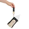 A hand holding a baby bottle warmer with a strap. Produktbild-Vorschau