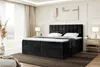 A bedroom scene with a large black upholstered bed as the main focus. Produktbild-Vorschau