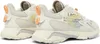 A pair of white and cream Lacoste sneakers shown from a side-back angle. Produktbild-Vorschau
