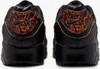 The back view of a pair of black Nike Air Max 90 sneakers with orange and gold accents. Anteprima dell’immagine prodotto