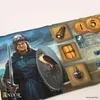 A close-up of a board game with illustrated characters and game pieces. Náhľad obrázku produktu