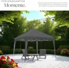 A grey gazebo set up on a paved patio in a garden, with chairs and a table underneath. Náhled obrázku produktu
